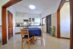 a kitchen with a table and chairs in a room at Private pool villa walking distance to the centre in Loulé