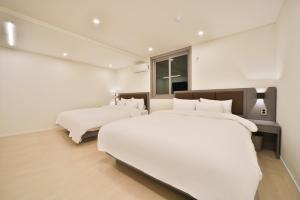 Postel nebo postele na pokoji v ubytování Green B Hotel Busan Seomyeon