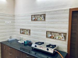 a kitchen with a stove on a counter in a room at Egmore P V Cherian Road 4bhk in Chennai