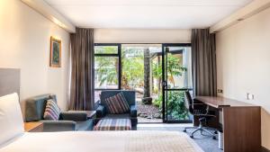 a hotel room with a bed and a desk at Holiday Inn Auckland Airport, an IHG Hotel in Auckland
