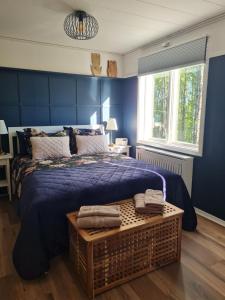 a blue bedroom with a large bed with a blue bedspread at Tulip Adventure in Deje