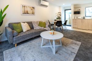 a living room with a couch and a table at Beachside Haven 1 bed 1 bath in Christchurch