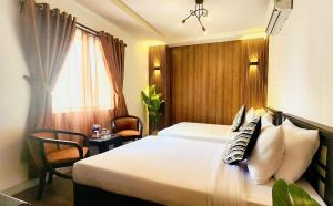 Giường trong phòng chung tại Rosa May Hotel