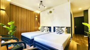 Giường trong phòng chung tại Rosa May Hotel