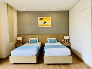 a bedroom with two beds and two lamps at Vila Lotus Hạ Long in Ha Long +11 photos