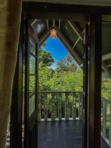 an open door to a balcony with trees at Beragala Serene Villa in Beragala