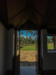 an open door with a view of a yard at Beragala Serene Villa in Beragala