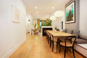 a dining room and living room with a table and chairs at The Bronte Breeze in Sydney