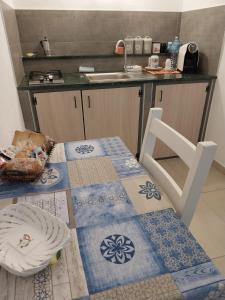 a kitchen with a table with a plate and a sink at On the road in Telti