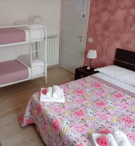a bedroom with a bed with towels on it at B&B Villa Rosa new in SantʼAntonio Abate