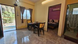 a dining room with a table and chairs in a room at Hotel Jampore Inn in Daman