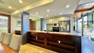 a kitchen with a counter with a sink and a stove at Allawah Port Douglas in Port Douglas