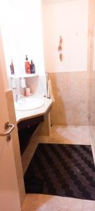 a bathroom with a sink and a shower at Jabal Sifah Tha Marina View Apartment in Muscat