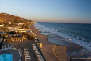 an aerial view of a beach and the ocean at Malibu Sand Carbon Beach Suites in Malibu