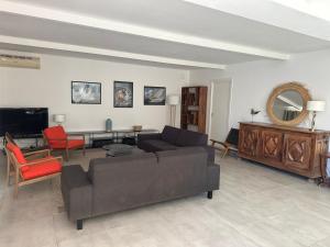 a living room with a couch and a table at Casa Canetto, vous y êtes déjà! 14 personnes in Bonifacio