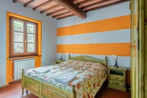 a bedroom with a bed and a window at Il Serrino 2 in Spignana