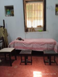 Zimmer mit einem Tisch, 2 Stühlen und einem Fenster in der Unterkunft Green Fields in Colovale