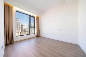 an empty room with a large window with a city view at 全新民宿 人民广场 欣赏外滩美景 落地窗大平层 靠近新天地 淮海路 in Shanghai