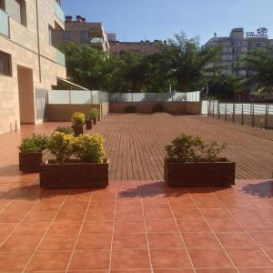 a patio with three potted plants on it at Calella Can Saula ll in Calella