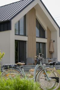 two bikes parked in front of a house at Harmonia Horyniec in Horyniec