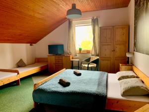 a bedroom with two beds and a window at Pension Aqualand in Poprad