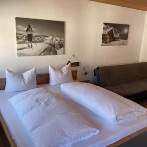 a bed in a hotel room with a person on the wall at Landgasthof Dorfstadl in Kössen