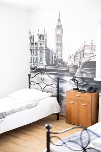a bedroom with a view of big ben in london at Leo Hostel in Poznań