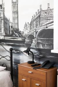 a bedroom with a desk with a drawing of a bridge at Leo Hostel in Poznań