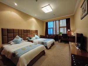 Postel nebo postele na pokoji v ubytování Chongqing Milky Way Hotel