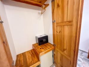 a door to a room with a microwave and a stove at Rain Hotel in Kizkalesi
