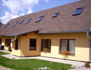 a house with solar panels on the roof at Guest House Privat Marika in Závažná Poruba