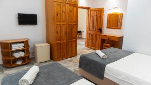 a bedroom with a bed and a desk and a television at Rain Hotel in Kizkalesi
