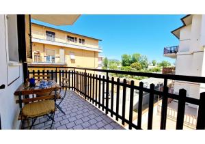 a balcony of a building with a table and chairs at Conero 33 Primo Piano Casa Vacanze in Numana