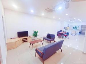 a living room with a couch and chairs and a tv at 90 Home4Stay 2storeySemi-D gurney&beach Shopping local food in Tanjung Bungah