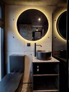 a bathroom with a sink and a mirror at Edge Oslo - Hideaway with Breathtaking City Views in Oslo