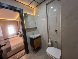 a bathroom with a toilet and a sink and a shower at Rain Hotel in Kizkalesi