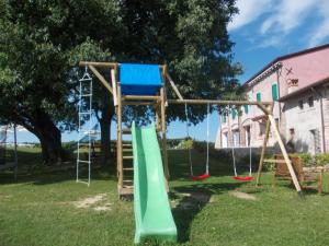 a playground with a slide in a yard at Agriturismo Bosco Del Gal in Castelnuovo del Garda