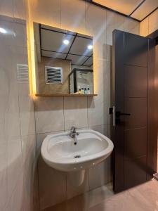 a bathroom with a sink and a mirror at Rain Hotel in Kizkalesi