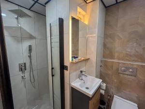 a bathroom with a shower and a sink and a toilet at Rain Hotel in Kizkalesi