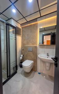 a bathroom with a toilet and a sink at Rain Hotel in Kizkalesi