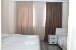Rúm í herbergi á VST KHANOYAN'S HOTEL