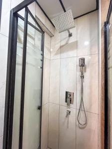 a shower in a bathroom with a glass door at Rain Hotel in Kizkalesi