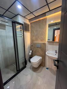 a bathroom with a toilet and a sink at Rain Hotel in Kizkalesi