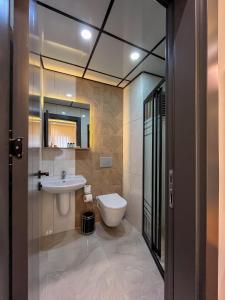 a bathroom with a toilet and a sink at Rain Hotel in Kizkalesi