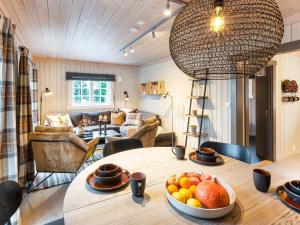 a room with a table with a bowl of fruit on it at 10 person holiday home in Fåvang in Strande