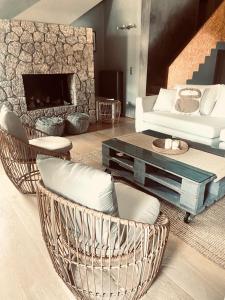 ein Wohnzimmer mit Korbstühlen und einem Sofa in der Unterkunft Le Blanc in Dassia