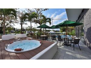 a hot tub on a deck with a table and chairs at Green Rich Hotel Okinawa Nago - Vacation STAY 55405v in Nago