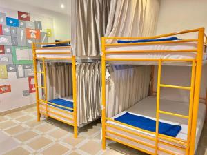 two bunk beds are in a room with at Ehome Saigon - Gạo hostel in Ho Chi Minh City