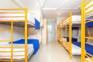 a room with four bunk beds and a hallway at Ehome Saigon - Gạo hostel in Ho Chi Minh City