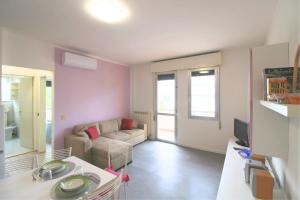 a living room with a couch and a table at Holiday in Caorle